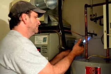 this is a picture of a local electrician in Fort Lauderdale, Florida working on a home water heater