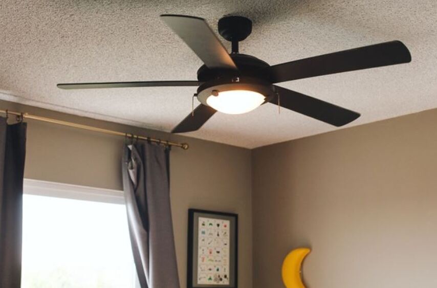 image of a brown ceiling fan installed in a bedroom